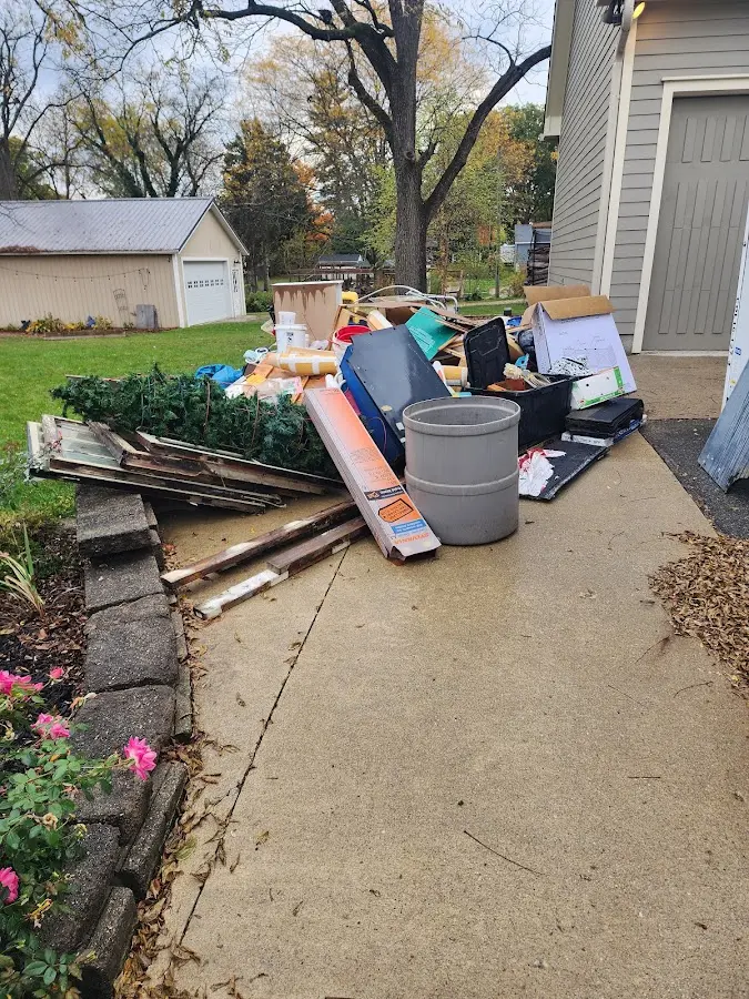 Dumpster being loaded with debris for Estate Cleanout Dumpster Rental in Tuckerton